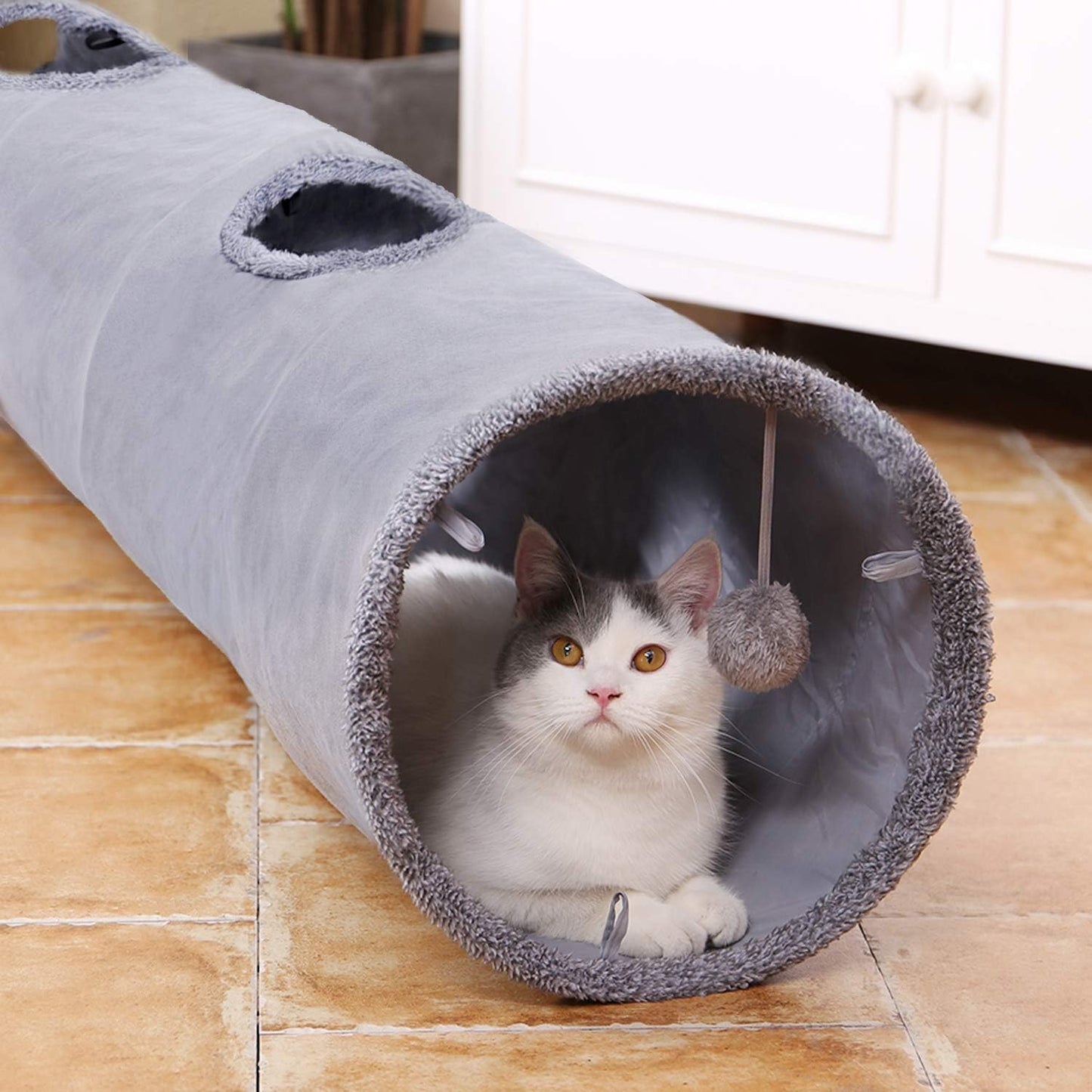 "🎉 Unleash the Fun! 🐾 Check out our Collapsible Cat Tunnel - the ultimate playtime hideaway for your furry friend! 🐱✨ Durable suede, crinkle sounds, and a fun ball included! 🐾💖 #CatLovers #PetPlaytime"